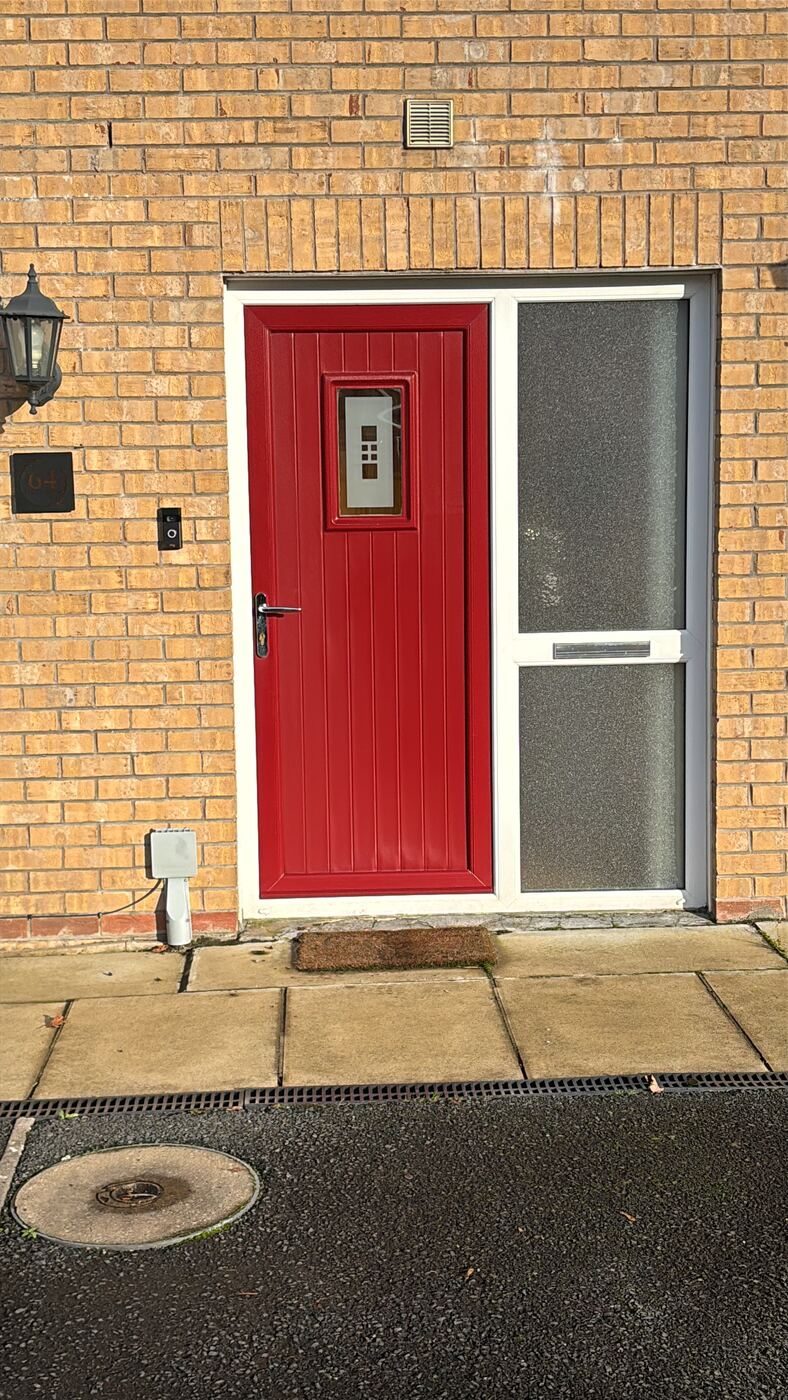Red composite door with small square glass panel